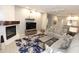 Open-concept living room features a fireplace, comfortable seating, and access to the kitchen at 7021 E Earll Dr # 204, Scottsdale, AZ 85251