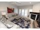 Bright living room features modern furnishings, fireplace, and access to outdoor patio at 7021 E Earll Dr # 204, Scottsdale, AZ 85251