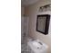 Clean bathroom with white vanity, framed mirror, shower/tub combo, and a neutral color scheme at 7109 W Wolf St, Phoenix, AZ 85033