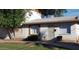 Charming single-story home with white siding, mature trees, and well-maintained landscaping at 7109 W Wolf St, Phoenix, AZ 85033