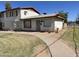 Charming single-Gathering home with a well-maintained lawn and a concrete walkway leading to the entrance at 7109 W Wolf St, Phoenix, AZ 85033