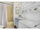 Bathroom with standing shower, granite sink, and stacked laundry machine at 730 S Country Club Dr # Ofc, Mesa, AZ 85210