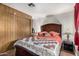 Comfortable bedroom showcasing a queen-sized bed with a lovely quilt and matching decor at 730 S Country Club Dr # Ofc, Mesa, AZ 85210