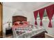 Bright bedroom featuring a queen-sized bed with a quilt and matching lamps at 730 S Country Club Dr # Ofc, Mesa, AZ 85210