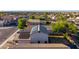 Aerial view showcasing a home with solar panels and a low-maintenance yard in a well-maintained neighborhood at 7319 S 56Th Dr, Laveen, AZ 85339