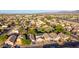 This aerial view looks over the community with the park in the middle of the frame on a sunny day at 7319 S 56Th Dr, Laveen, AZ 85339