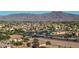 Aerial view showing mountain views and location, displaying neighborhood with green space and proximity to shopping at 7319 S 56Th Dr, Laveen, AZ 85339