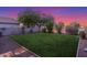 A well-maintained lawn in a fenced backyard at sunset at 7319 S 56Th Dr, Laveen, AZ 85339