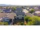 Aerial view of the home's backyard with some trees, a small lawn, and view of neighborhood at 7319 S 56Th Dr, Laveen, AZ 85339
