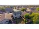 Aerial view of the backyard featuring a minimal grass lawn surrounded by residential neighborhood and partial landscape at 7319 S 56Th Dr, Laveen, AZ 85339