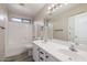 Bright bathroom with double vanity, tub, and wood-look tile floors at 7319 S 56Th Dr, Laveen, AZ 85339