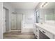 Well-lit bathroom featuring a tub and shower with a double sink vanity at 7319 S 56Th Dr, Laveen, AZ 85339