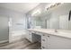 Bright bathroom features a bathtub and shower with a double sink vanity at 7319 S 56Th Dr, Laveen, AZ 85339