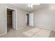Neutral-toned bedroom with carpeted floor, closet and ceiling fan at 7319 S 56Th Dr, Laveen, AZ 85339