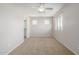 A large bedroom featuring carpeted floors, a ceiling fan, and a sunlit windows at 7319 S 56Th Dr, Laveen, AZ 85339