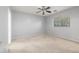 Bedroom with neutral carpet, a ceiling fan, and a window providing natural light at 7319 S 56Th Dr, Laveen, AZ 85339