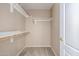 Walk-in closet featuring carpet floors, white shelving, and a neutral wall color at 7319 S 56Th Dr, Laveen, AZ 85339
