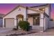 Daylight view of home highlighting the covered porch, two-car garage, and neutral facade at 7319 S 56Th Dr, Laveen, AZ 85339