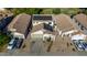 Aerial view showcasing a home with solar panels, desert landscaping, and a two-car garage in a residential area at 7319 S 56Th Dr, Laveen, AZ 85339