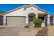 Welcoming home exterior with two-car garage, neutral color scheme, and easy-care landscaping at 7319 S 56Th Dr, Laveen, AZ 85339