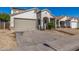 Lovely home exterior with a large driveway, desert landscaping, and two-car garage at 7319 S 56Th Dr, Laveen, AZ 85339