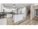 Spacious kitchen with white cabinets, stainless steel appliances, and an adjoining staircase at 7319 S 56Th Dr, Laveen, AZ 85339