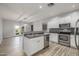 Modern kitchen with stainless steel appliances, wood floors, and bright white cabinets at 7319 S 56Th Dr, Laveen, AZ 85339