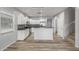 Open kitchen featuring white cabinetry, stainless steel appliances, and a gray backsplash at 7319 S 56Th Dr, Laveen, AZ 85339