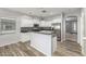 Bright kitchen boasting white cabinets, a stainless steel refrigerator, and wood-look floors at 7319 S 56Th Dr, Laveen, AZ 85339