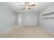 Comfortable living room featuring carpet, ceiling fan, and view into other rooms at 7319 S 56Th Dr, Laveen, AZ 85339