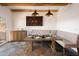 Dining room with a long wooden table, designer lighting, and a built-in bench at 7530 N Via De La Siesta --, Scottsdale, AZ 85258