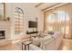 Open-concept living room with fireplace, beamed ceiling, and modern decor at 7530 N Via De La Siesta --, Scottsdale, AZ 85258