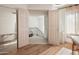 Bright room with wood floors, double doors to stairs, massage table, and a large mirror at 7530 N Via De La Siesta --, Scottsdale, AZ 85258