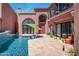 Private pool with tiled patio, cacti, and archways leading to the house at 7530 N Via De La Siesta --, Scottsdale, AZ 85258