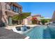 Beautiful pool area features a waterfall, two lounge chairs, and desert landscaping at 7530 N Via De La Siesta --, Scottsdale, AZ 85258