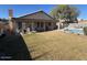 Expansive backyard featuring a pool, lush lawn, and covered patio for outdoor enjoyment at 7813 E Covina St, Mesa, AZ 85207