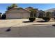 Charming home with a large three-car garage and well-maintained front yard landscaping at 7813 E Covina St, Mesa, AZ 85207