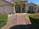 Charming front entrance with brick walkway, manicured bushes, and desert landscaping at 7813 E Covina St, Mesa, AZ 85207