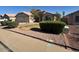 Well-maintained front yard with lush bushes and decorative rock landscaping enhancing the curb appeal at 7813 E Covina St, Mesa, AZ 85207