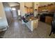 Open kitchen featuring wooden cabinetry, tile floors, and granite countertops at 7813 E Covina St, Mesa, AZ 85207