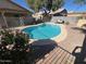 Backyard oasis with refreshing pool, beautiful plants, and comfortable lounge area for relaxation at 7813 E Covina St, Mesa, AZ 85207