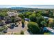 Expansive aerial view of the neighborhood and mature landscaping, home, and mountain views at 8302 S Jentilly Ln, Tempe, AZ 85284