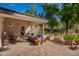 Charming brick back patio featuring mature landscaping, seating and an outdoor living area at 8302 S Jentilly Ln, Tempe, AZ 85284