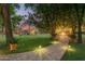 Charming backyard pathway leading to a pool and lounge area with a firepit at 8302 S Jentilly Ln, Tempe, AZ 85284