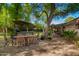 Spacious backyard patio with a large dining table and outdoor bar, perfect for entertaining at 8302 S Jentilly Ln, Tempe, AZ 85284