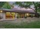 Back of house with dining area visible through window, and patio with plant accents at 8302 S Jentilly Ln, Tempe, AZ 85284