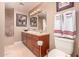 Neutral bathroom with a granite countertop, tile flooring, and warm wood cabinets at 8302 S Jentilly Ln, Tempe, AZ 85284