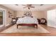 Bedroom featuring ceiling fan, hardwood floors, and patio access at 8302 S Jentilly Ln, Tempe, AZ 85284