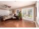 Primary bedroom featuring hardwood floors, patio access, and ceiling fan at 8302 S Jentilly Ln, Tempe, AZ 85284
