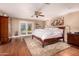 Spacious bedroom featuring hardwood floors, French doors, and large windows providing ample natural light at 8302 S Jentilly Ln, Tempe, AZ 85284